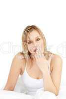 Charming woman yawning on her bed