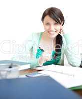Beautiful teen girl studying at her desk