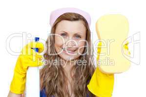Cheerful woman holding a sponge and a detergent spray