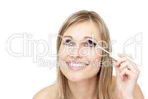 Jolly woman putting mascara
