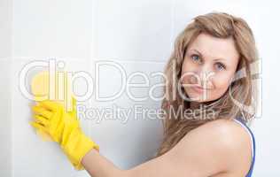 Young woman cleaning a bathroom