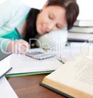 Brunette student doing her homework on a desk