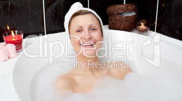 Cheerful attractive woman in a bubble bath