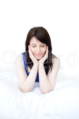 Portrait of a tired woman sitting on her bed