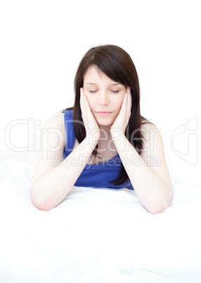Tired woman sitting on her bed