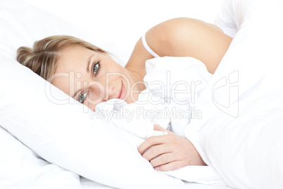 Bright woman relaxing lying on her bed