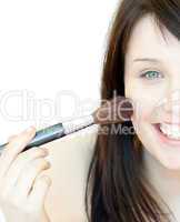 Cheerful woman using a powder brush