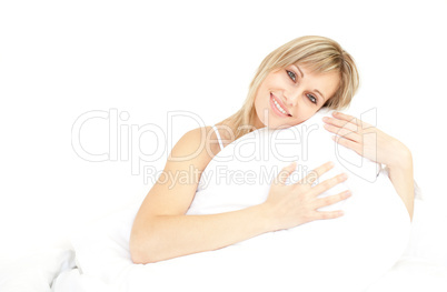 Smiling woman hugging her pillow