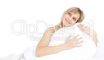 Cheerful woman hugging her pillow