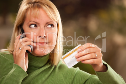 Cheerful Woman Using Her Phone with Credit Card