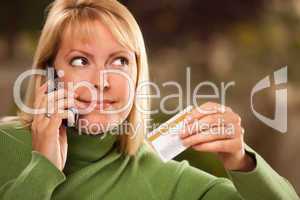 Cheerful Woman Using Her Phone with Credit Card