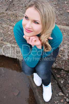 blonde in blue sweater and jeans