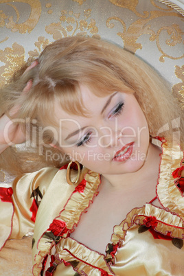 girl in robe rests upon beds