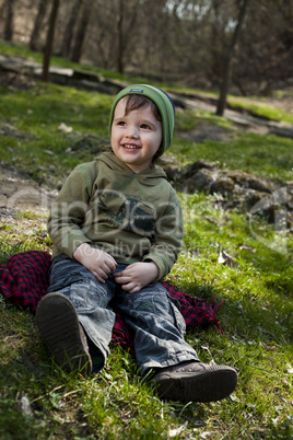 Little boy sitting on a scarf
