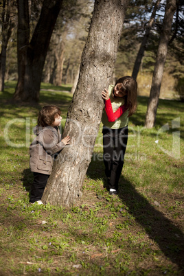 Boy and girl playing in forest