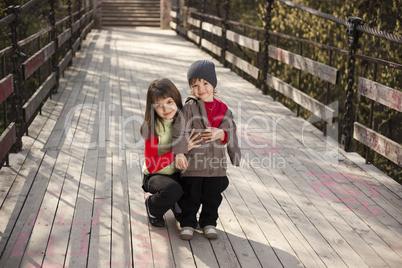 Girl and little boy posing at camera