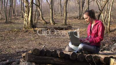 Woman working with laptop on the nature