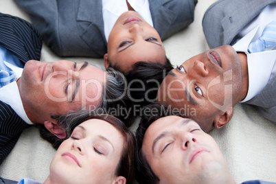 Close-up of relaxed business team lying in circle