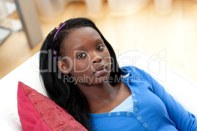 Portrait of an upset woman lying on a sofa