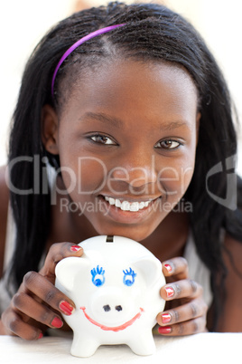 Bright teen girl holding a piggy-bank