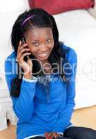 Smiling woman talking on phone in the living-room