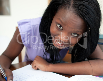 Portrait of a cheerful teen girl studying