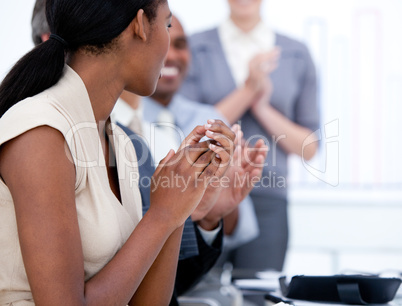 Happy business team applauding in a meeting