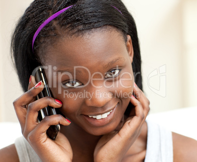 Smiling woman on phone in the living-room