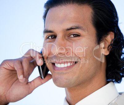 Portrait of a smiling business man using a cellphone