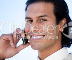 Portrait of a smiling business man using a cellphone