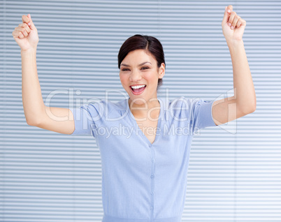 Successful businesswoman punching the air in celebration