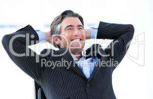 Laughing male executive thinking about his success