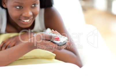 Young woman watching TV in the living-room