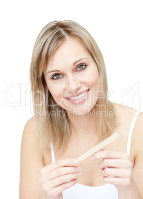 Portrait of a charming woman filing her nails