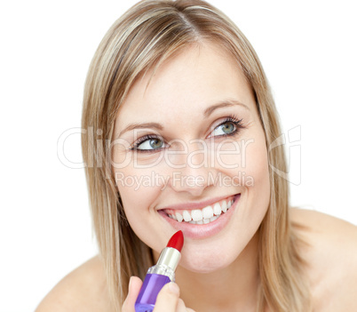Portrait of a charismatic woman putting red lipstick