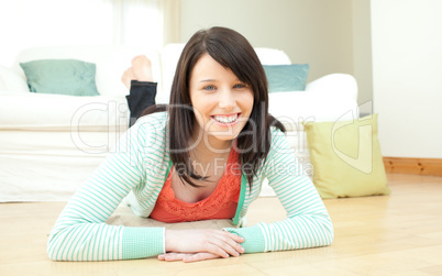 Radiant woman lying down on the floor in the living room