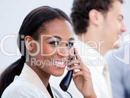 Smiling Afro-American businesswoman talking on phone