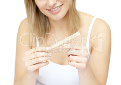 Portrait of a smiling woman filing her nails