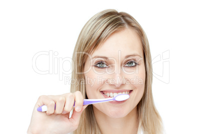 Portrait of a blond woman brushing her teeth