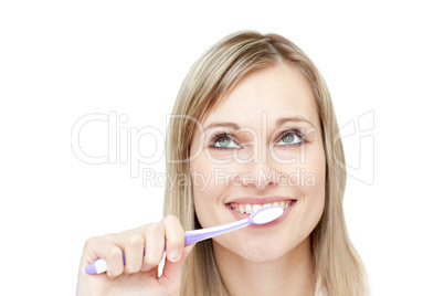 Portrait of an attractive woman brushing her teeth