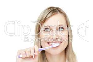 Portrait of an attractive woman brushing her teeth