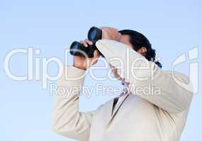 Portrait of an handsome business man looking through binoculars