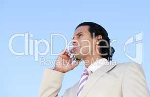 Portrait of an handsome business man using a cellphone