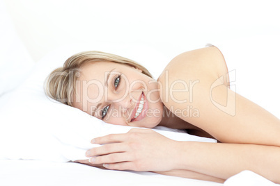 Bright woman relaxing on her bed