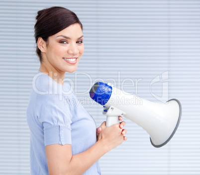 Smiling businesswoman holding a megaphone