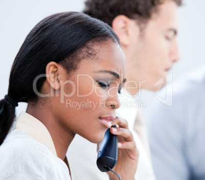 Concentrated Afro-American businesswoman talking on phone