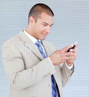 Attractive businessman sending a text