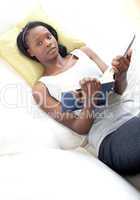 Beautiful woman reading lying on a sofa