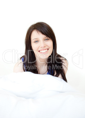 Portrait of a bright woman sitting on bed