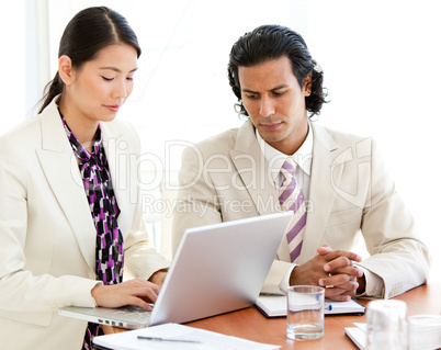 Concentrated business people working at a laptop